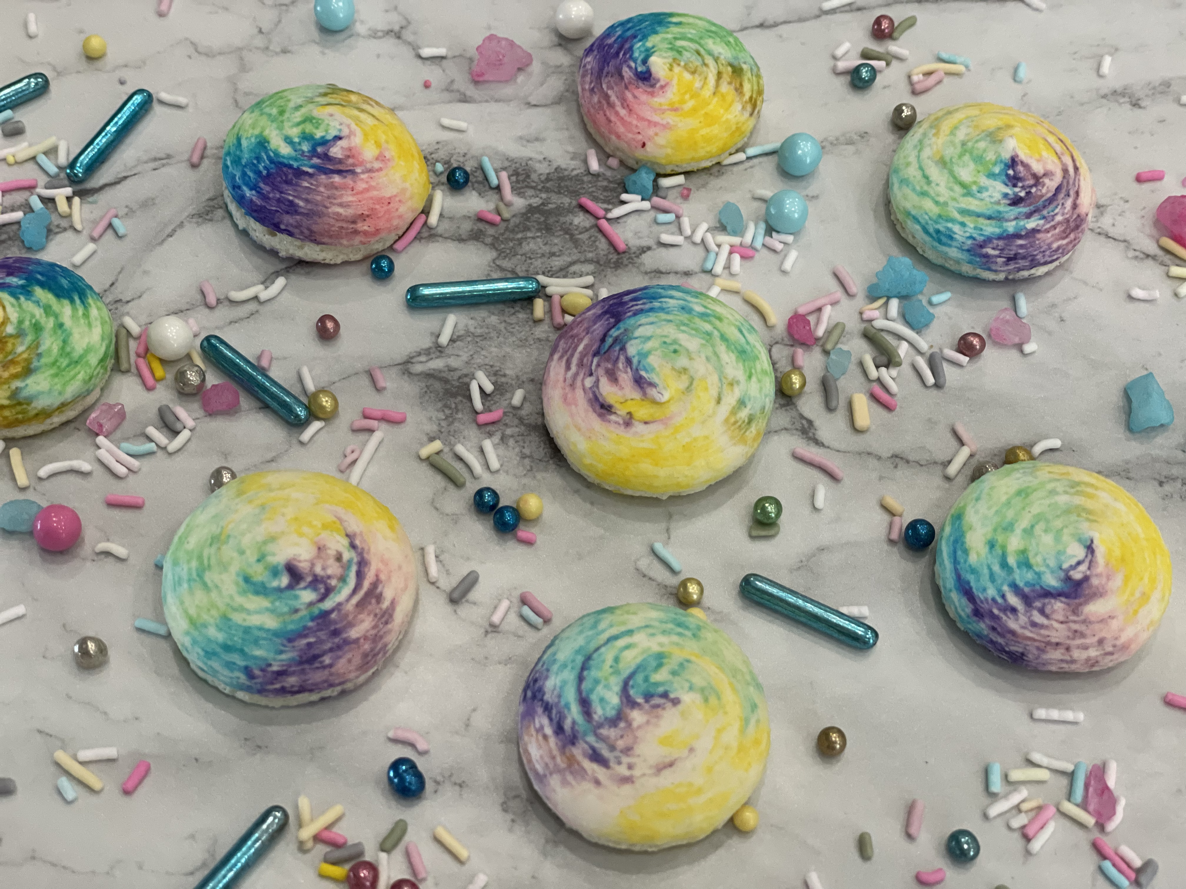 the princess baker shows you how to make multi color rainbow macarons by striping the piping bag with gel food coloring