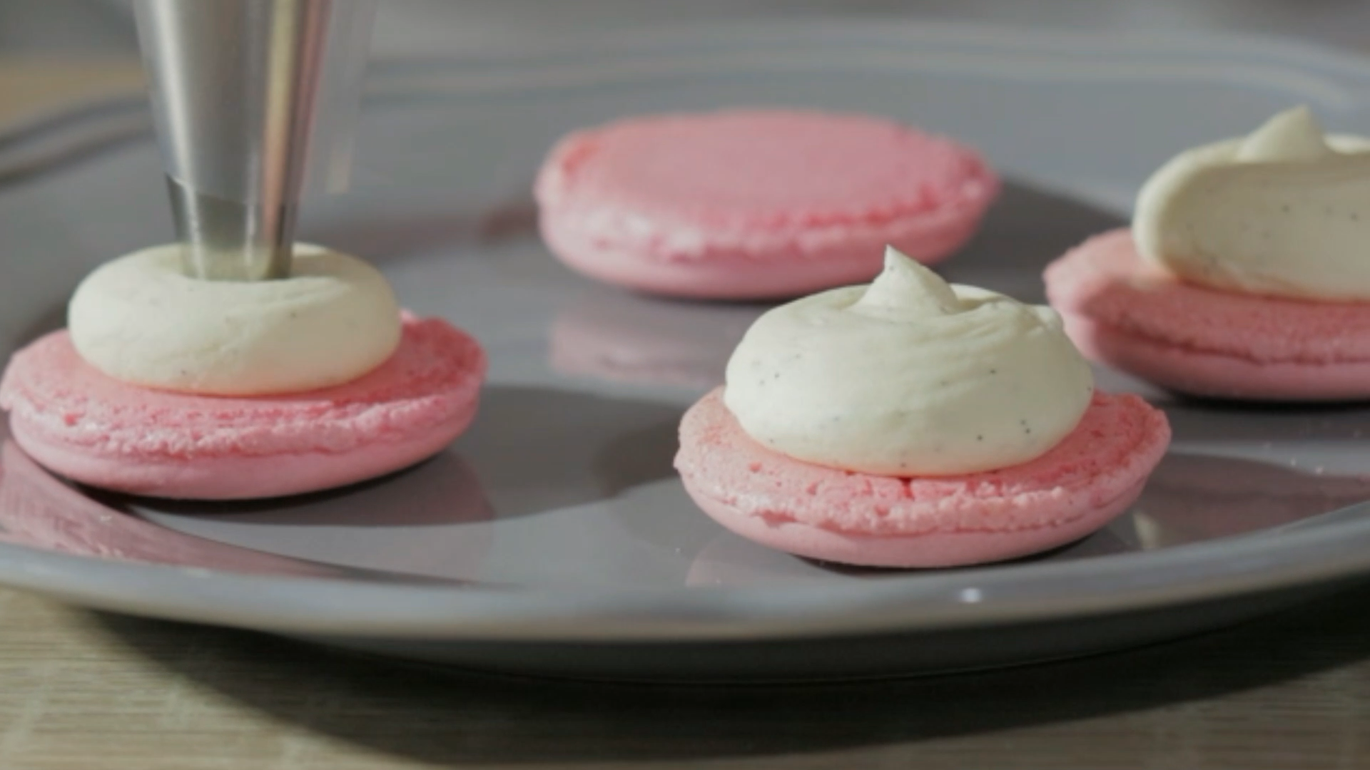 the princess baker shows you how to flavor macarons by piping different flavors of buttercreams and ganache inside the shells