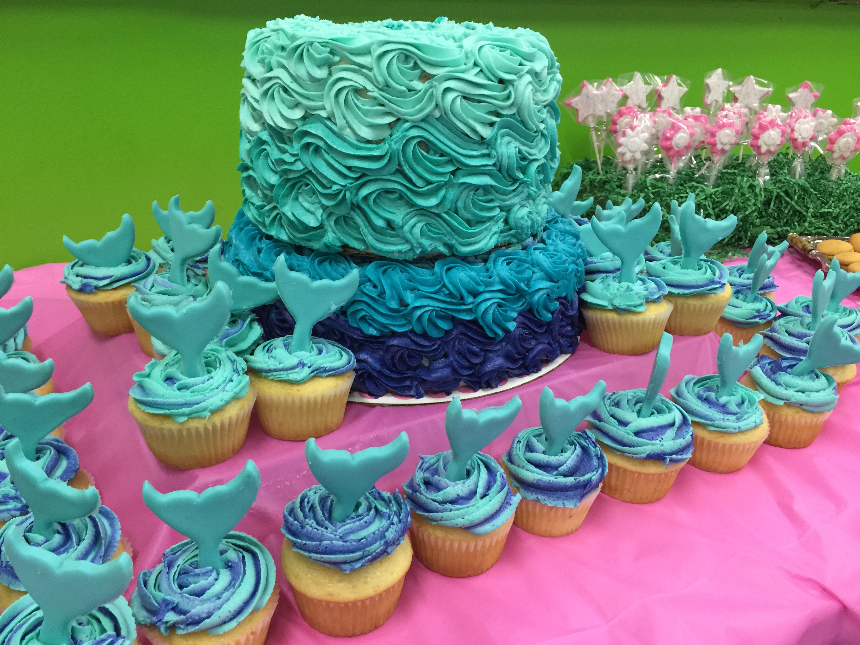 American Buttercream can be colored any shade. This under the sea mermaid cake and cupcakes use swirls to mimic ocean waves for a birthday party